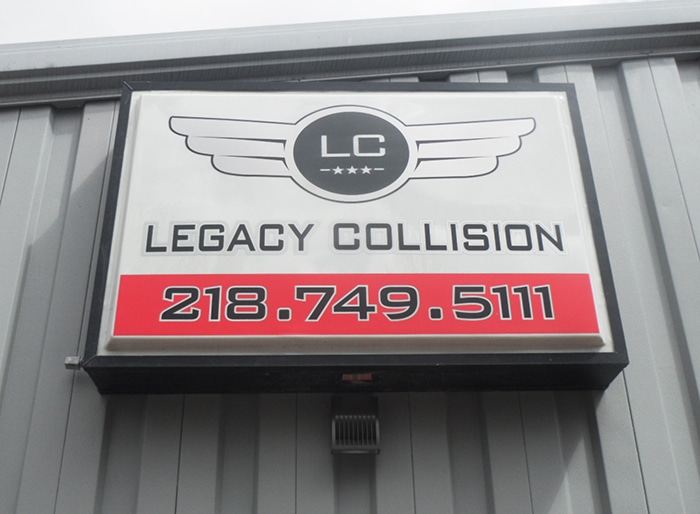 Sign with logo and phone number for collision repair